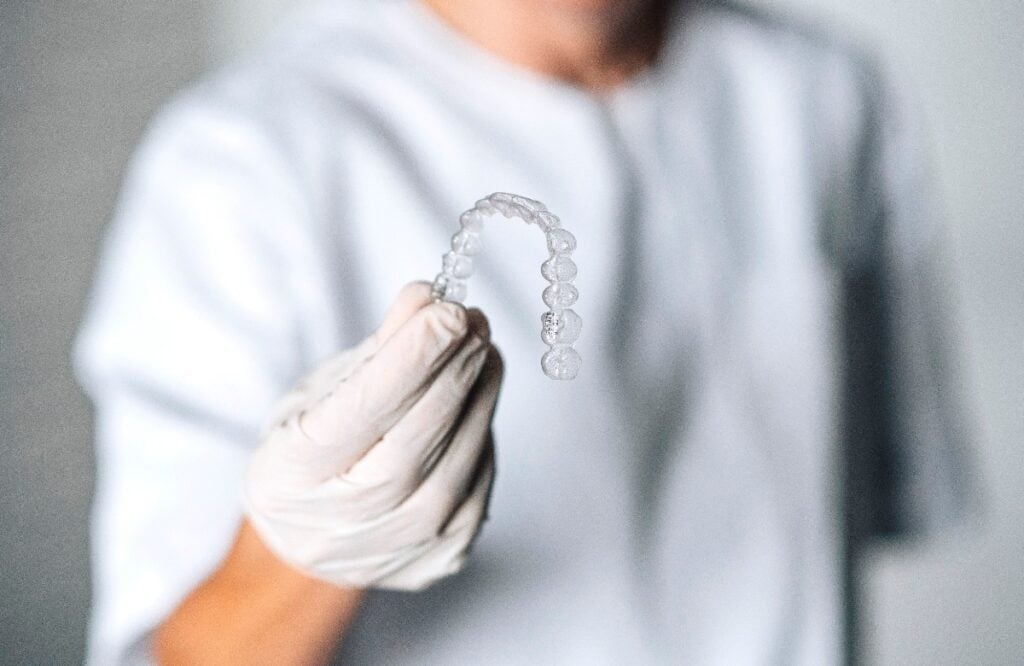 People in a dental lab working in the fabrication process of dental transparent aligners